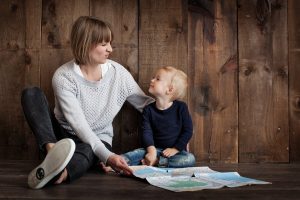 child with woman holding map